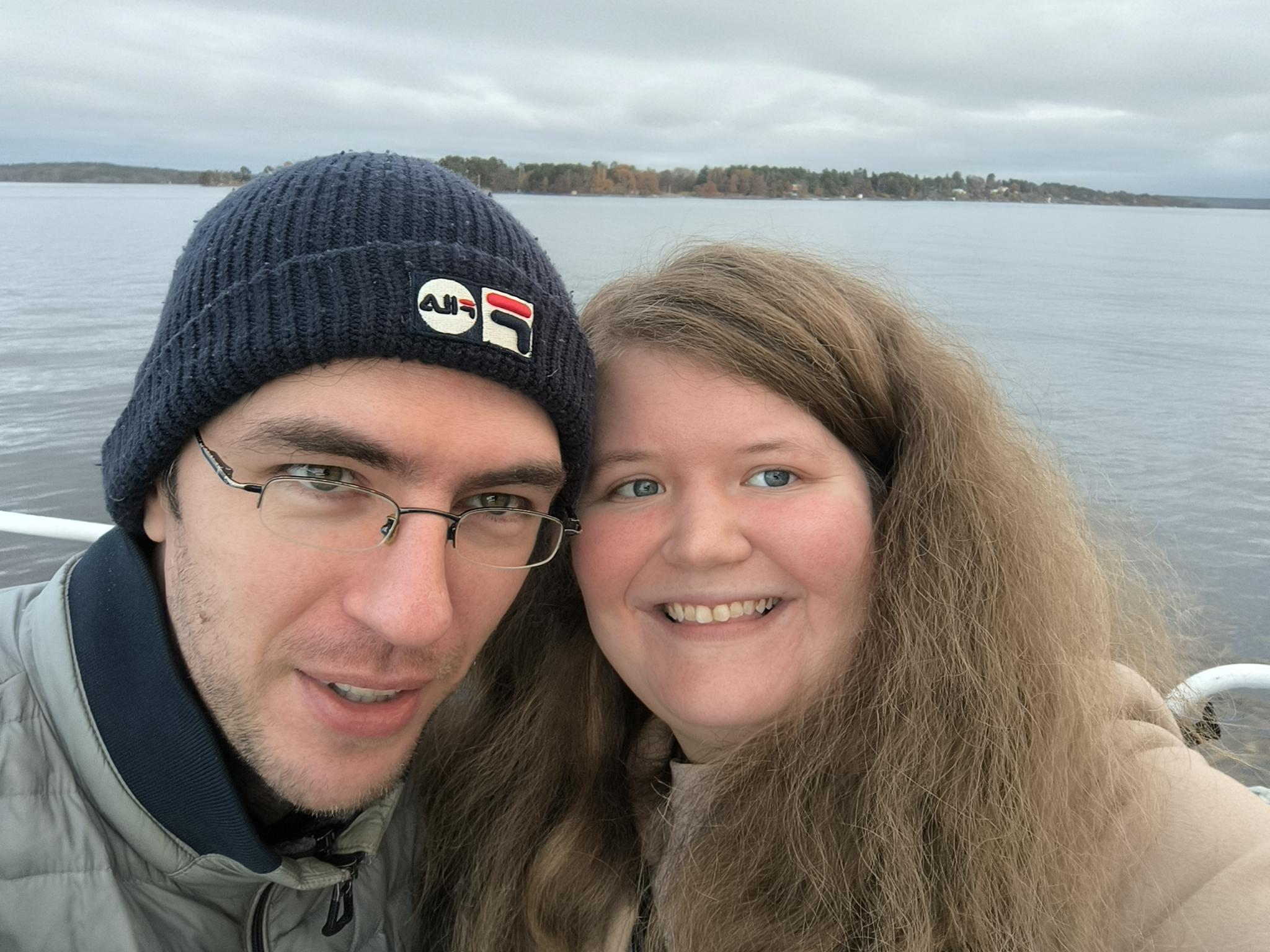 A picture of Alex and Joanne standing in front of a lake